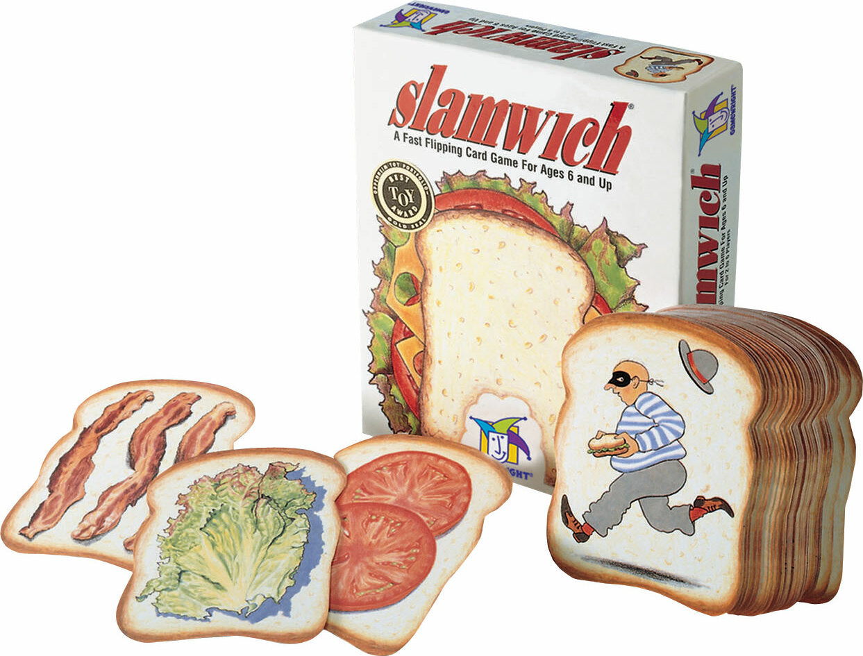 The Slamwich game by Gamewright features a box displaying the title and description. Next to the box are unique sandwich-shaped cards depicting various ingredients like bacon, lettuce, and tomato, alongside a playful character in a black mask, all designed for fast-paced card flipping fun.