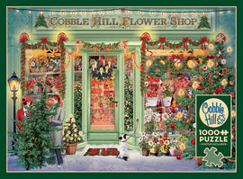 A vibrant jigsaw puzzle featuring a cozy Christmas flower shop adorned with festive decorations. The charming shopfront is framed by wreaths, garlands, and lights, showcasing an array of colorful flowers and holiday greens. Two people are outside, one holding a small tree, with a cute dog nearby on a snowy ground, creating a warm holiday scene.