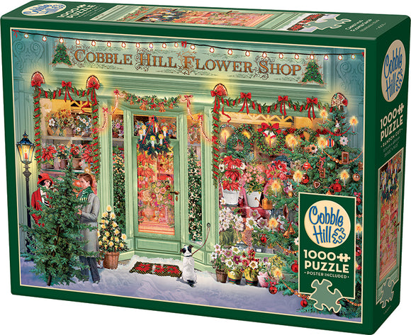 A beautifully illustrated jigsaw puzzle box featuring a picturesque Christmas flower shop adorned with festive decorations. The shopfront is decked with lights and colorful floral arrangements, depicting people interacting in a snowy setting, with a small dog and a variety of Christmas plants visible. The puzzle contains 1000 pieces and includes a poster for reference.
