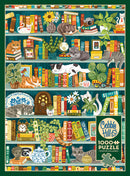 The Purrfect Bookshelf jigsaw puzzle by Cobble Hill featuring a colorful illustration of a bookshelf filled with various books, plants, and playful cats nestled among the items. The design showcases a vibrant, cozy atmosphere perfect for cat lovers and puzzle enthusiasts alike. Includes a poster for reference.