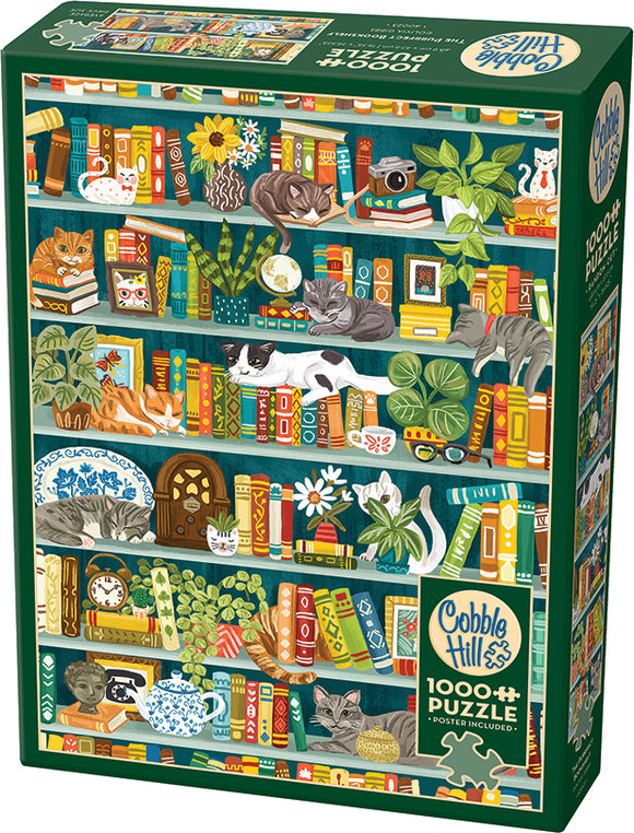 The Purrfect Bookshelf jigsaw puzzle by Cobble Hill features an intricately illustrated bookshelf filled with colorful books, various plants, and adorable cats relaxing among them. The puzzle contains 1000 pieces and showcases a cozy reading atmosphere, making it an ideal choice for cat lovers and puzzle enthusiasts alike.