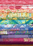 A vibrant jigsaw puzzle image featuring a collection of colorful quilt fabric patterns stacked in horizontal rows. The fabrics include floral designs and various textures in shades of pink, green, blue, and purple, creating a visually appealing array of colors.