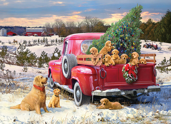 A vibrant jigsaw puzzle image titled 'Family Outing' featuring a red vintage truck filled with playful golden retriever puppies. The truck is parked in a snowy landscape adorned with a Christmas tree and surrounded by a farm setting with a barn in the background. The scene captures a joyful, heartwarming family outing atmosphere with snow-covered ground, evergreen trees, and playful dogs, perfect for family bonding through puzzle solving.
