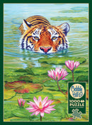 A vibrant jigsaw puzzle titled 'Land of the Lotus' by Cobble Hill, featuring a majestic tiger partially submerged in water surrounded by pink lotus flowers and green lily pads. The artwork showcases rich colors and intricate details, creating a serene and beautiful scene.