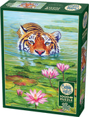 The Cobble Hill jigsaw puzzle titled "Land of the Lotus" features a stunning and vibrant illustration of a tiger emerging from a tranquil water scene, surrounded by lily pads and pink lotus flowers. The packaging highlights that it contains 1000 pieces and includes a poster.