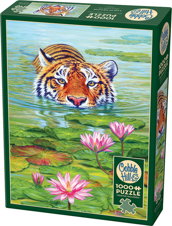 The Cobble Hill jigsaw puzzle titled "Land of the Lotus" features a stunning and vibrant illustration of a tiger emerging from a tranquil water scene, surrounded by lily pads and pink lotus flowers. The packaging highlights that it contains 1000 pieces and includes a poster.