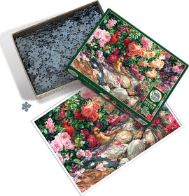 The Garden Wall jigsaw puzzle by Cobble Hill features an intricate illustration of a lush garden with vibrant flowers and colorful birds. The puzzle box is partially open, showcasing the numerous puzzle pieces inside and a colorful image of the completed puzzle on the lid.