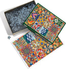 Twelve Days of Christmas Quilt jigsaw puzzle by Cobble Hill. The image shows a colorful puzzle box with a vibrant quilt design and a partially completed layout of the pieces. The box is open revealing numerous jigsaw pieces inside, alongside the cover illustration.