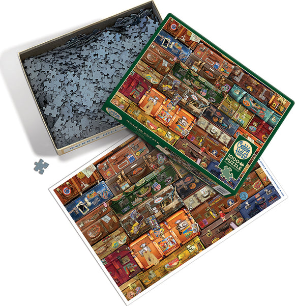 A Cobble Hill jigsaw puzzle featuring a colorful collage of vintage suitcases, displayed in an open box. The puzzle includes many intricate pieces scattered in the box, and a reference image of the completed puzzle showing a vibrant arrangement of different suitcase designs, with labels and stickers adding character.