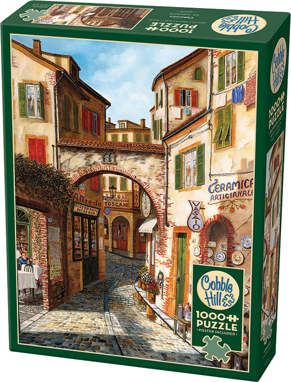 Cobble Hill Ceramica jigsaw puzzle featuring a scenic Tuscan street illustration. The artwork depicts rustic buildings, colorful signs, and a quaint atmosphere. This 1000-piece puzzle promises hours of engaging entertainment for puzzle enthusiasts and art lovers alike.