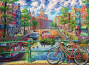 A vibrant jigsaw puzzle depicting a picturesque Amsterdam canal scene. Colorful houses line the canal, showing blooming flowers and a charming bridge, with a bicycle parked in the foreground. The lively atmosphere includes boats on the water and people strolling along the canal.