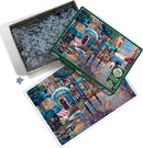 The Cobble Hill jigsaw puzzle titled "Rainy Day Stroll" features a colorful scene of a charming street with shops and flowers, surrounded by a rainy atmosphere. The puzzle box is open, displaying a variety of interlocking pieces inside, with an image of the completed puzzle next to it.