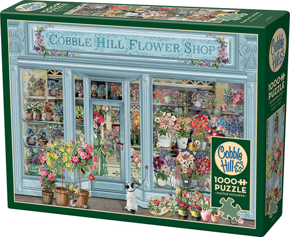 The Cobble Hill 'Parisian Flowers' jigsaw puzzle, featuring a beautifully illustrated flower shop exterior filled with vibrant flowers in pots. The puzzle has 1000 pieces and includes a poster for reference. A cute dog is seen at the entrance, adding charm to the scene.