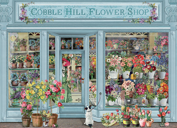 A colorful jigsaw puzzle featuring the charming Cobble Hill Flower Shop. The illustration showcases a vibrant flower shop with various flower arrangements, pots, and a whimsical scene including a person in a green dress and a dog at the entrance. The shop's exterior is adorned with intricate details and floral motifs, inviting viewers to piece together this enchanting floral scene.
