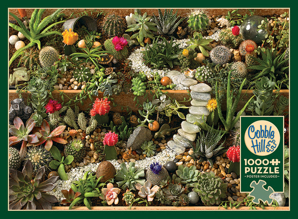 A vibrant jigsaw puzzle featuring a succulent garden overflowing with various cacti, succulents, colorful flowers, and small ornamental stones. The intricate details of the plants showcase a rich variety of textures and colors, inviting nature enthusiasts to piece together this beautiful scene. The Cobble Hill brand logo is featured prominently on the packaging, highlighting that this is a 1000-piece puzzle that includes a poster for reference.