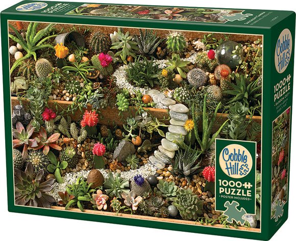 Cobble Hill 1000-piece jigsaw puzzle titled 'Succulent Garden'. The puzzle box features a vibrant image of a lush, detailed succulent garden, showcasing various cacti and succulents in rich colors, arranged in a visually stunning display with pebbles and decorative stones.