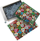 A colorful jigsaw puzzle featuring an assortment of sugar skull cookies, decorated with vibrant icing and floral patterns, displayed on the box lid. The puzzle pieces are spread out in a box, showcasing a distinct and festive design perfect for puzzle enthusiasts and lovers of Día de los Muertos.