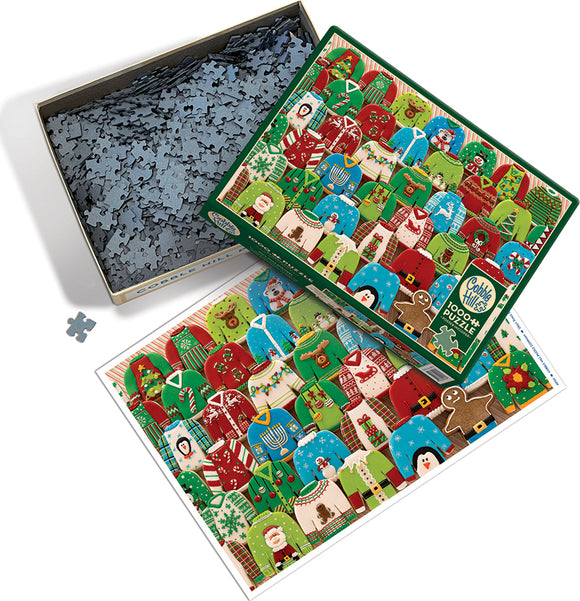 Cobble Hill Ugly Xmas Sweaters jigsaw puzzle with a colorful design featuring various Christmas sweaters in red, green, and blue, showing festive motifs like snowmen, Santa, and Christmas trees. The puzzle comes in a decorative box with some pieces scattered around it, hinting at the fun challenge of assembling 1000 pieces.