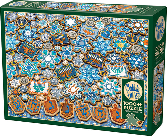A colorful jigsaw puzzle titled 'Hanukkah Cookies' by Cobble Hill. The image showcases intricately decorated cookies in various shapes, including Star of David and dreidels, featuring blue, white, and gold hues against a festive background. This 1000-piece puzzle promises a delightful challenge for puzzle enthusiasts and a great way to celebrate Hanukkah spirit.