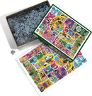 A vibrant jigsaw puzzle titled 'Doodlecats' by Cobble Hill. The image shows an open box with numerous jigsaw pieces scattered. The puzzle depicts a colorful illustration filled with playful cats in various scenarios, featuring bright colors and engaging artwork. The layout includes a picture of the completed puzzle, showcasing adorable cat characters and whimsical elements.