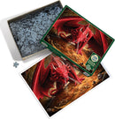 A 1000-piece jigsaw puzzle titled 'Dragon's Lair' by Cobble Hill. The illustration features a fierce red dragon amidst a treasure-filled cave, surrounded by skulls and gold. The puzzle pieces are shown in an open box, with an image of the completed puzzle displayed beside it.