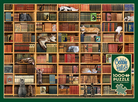 A colorful jigsaw puzzle titled 'The Cat Library' by Cobble Hill, featuring a detailed image of a bookshelf filled with various books and playful cats lounging among them. The puzzle contains 1000 pieces and includes a poster for reference.
