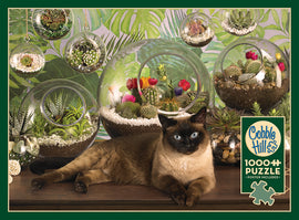 A cozy terrarium-themed jigsaw puzzle featuring a Siamese cat lounging on a wooden surface near various glass terrariums filled with succulent plants and colorful cactus flowers. The background is adorned with lush green tropical leaves. The puzzle contains 1000 pieces and includes a poster.