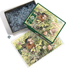 A beautifully illustrated jigsaw puzzle titled 'Hidden Nest' by Cobble Hill. The box is open, revealing an assortment of intricately shaped puzzle pieces. The image shows a serene scene of birds in a nest surrounded by vibrant greenery and flowers, perfect for nature lovers and puzzle enthusiasts.