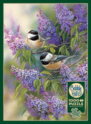 A beautiful jigsaw puzzle titled 'Chickadees and Lilacs' by Cobble Hill, featuring two adorable chickadee birds perched among vibrant purple lilacs. The design showcases intricate details of the birds and flowers, creating a serene and colorful scene, ideal for nature lovers and puzzle enthusiasts.