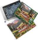 Cobble Hill jigsaw puzzle titled 'Mountain Thunder' featuring a scenic depiction of horses running through a beautiful landscape surrounded by mountains and greenery. The box is partially open with pieces visible inside.