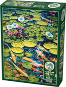 The Cobble Hill Koi Pond jigsaw puzzle features a vibrant, colorful scene depicting a serene koi pond surrounded by lily pads and blossoming flowers. This 1000-piece puzzle showcases intricate artwork that captures the harmony of nature, perfect for puzzle enthusiasts and nature lovers alike. The packaging includes a poster for reference, enhancing the puzzle-solving experience.