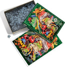 A colorful jigsaw puzzle titled 'Frog Business' by Cobble Hill. The puzzle box, open to reveal its contents, displays various vibrant frog illustrations on the lid, featuring different species in an array of colors. The puzzle pieces are arranged in the box, with a single piece set outside, on a white surface. An image of the completed puzzle is shown next to the box, emphasizing the intricate design of the frogs against a lush green background.