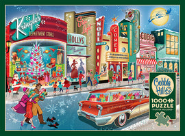 A vibrant and nostalgic jigsaw puzzle titled 'Vintage Main Street' by Cobble Hill, depicting a bustling holiday scene with a classic 1950s car, a decorated Christmas tree, and cheerful pedestrians shopping and celebrating in front of colorful storefronts like 'Kringle's Department Store' and 'Coco's Sweet Shop'. The artwork is rich in detail, capturing the warmth and joy of a vintage holiday season with snowy accents.