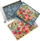 The 'Shooting the Breeze' jigsaw puzzle by Cobble Hill featuring a colorful illustration of flowers, a blue tit bird, and butterflies. The box is partially opened, revealing the puzzle pieces inside and the completed image displayed beside it.