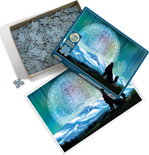 A Cobble Hill jigsaw puzzle titled 'Two Wolves'. The box features an artistic design with two wolves silhouetted against a mountainous landscape under a colorful sky. The lid of the box partially reveals puzzle pieces inside, while the included puzzle image showcases the wolves and the serene northern landscape.