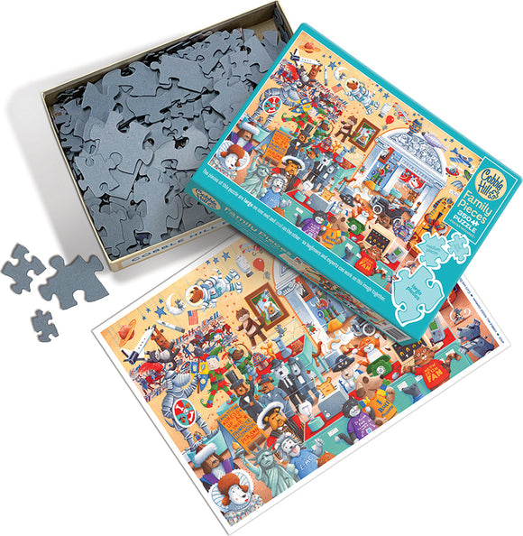 A colorful jigsaw puzzle titled 'Cats and Dogs Museum' by Cobble Hill. The box is open, showing puzzle pieces and an illustration of a vibrant museum scene filled with cats and dogs in various playful activities and costumes. Several loose puzzle pieces are also visible in the foreground.