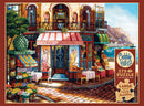 A vibrant jigsaw puzzle titled 'Chez Michelle' by Cobble Hill, featuring a picturesque café scene with a bistro and flower stalls, set in a charming coastal town. The puzzle has 275 large pieces, designed for easy handling, showcasing rich colors and intricate details.