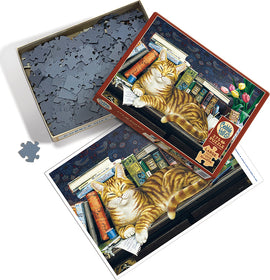 A Cobble Hill jigsaw puzzle featuring a relaxed orange tabby cat lounging atop a stack of colorful books, surrounded by a background of flowers and a patterned wall. The puzzle box is shown next to an unassembled piece, highlighting the intricate design and cozy ambiance.