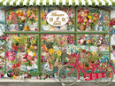 A vibrant jigsaw puzzle featuring a colorful flower and cactus shop. The shop's window displays an array of flowers and cacti in pots, with a vintage bicycle in front, adorned with flowers. The inviting storefront is decorated with a green and white striped awning and a sign reading 'Flowers & Cacti'.