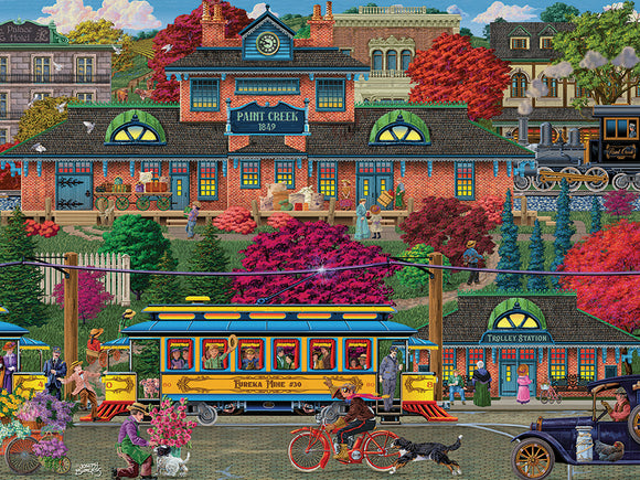 A colorful jigsaw puzzle scene depicting a bustling trolley station in a quaint town. The foreground features a blue trolley labeled 'Eureka Mine #30', people buying flowers, and a cyclist. The background showcases the brick building of 'Paint Creek 1849' surrounded by vibrant autumn foliage, a steam train nearby, and townsfolk engaging in various activities. The overall atmosphere is lively and nostalgic, perfect for puzzle enthusiasts.
