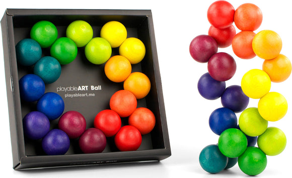 The Playable Art Ball by Beyond123 features a collection of colorful wooden spheres in a rainbow arrangement. The spheres are made of high-quality wood, polished to a smooth finish, and vary in color from vibrant red, orange, and yellow to serene green, blue, and purple. This engaging and tactile toy offers endless creativity as users can connect, twist, and shape the spheres into various designs, enhancing both visual appeal and sensory interaction.