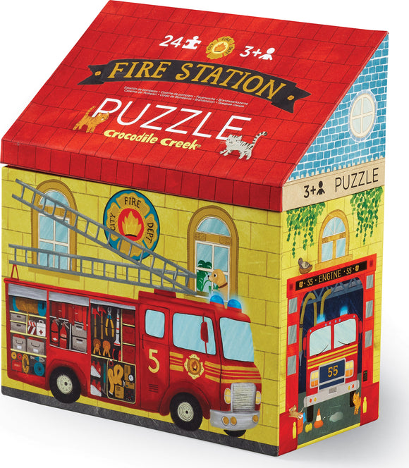 A colorful jigsaw puzzle box featuring a vibrant illustration of a fire station with a fire truck, ladder, and playful animals. The puzzle is designed for children aged 3 and up and includes 24 pieces.