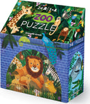 Crocodile Creek Puzzle Zoo jigsaw puzzle with 24 colorful pieces featuring a lion and its cubs, surrounded by tropical foliage and various animals. The box showcases whimsical illustrations of a giraffe, peacock, monkey, and more, appealing to young children aged 3 and up.