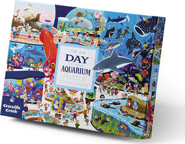 A colorful jigsaw puzzle box titled 'Day at the Aquarium' by Crocodile Creek. The packaging features vibrant illustrations of aquatic life, children interacting with marine animals, and scenes from an aquarium, showcasing fish, sharks, and playful oceanic adventures. The puzzle consists of 72 pieces, suitable for children aged 6 and up.