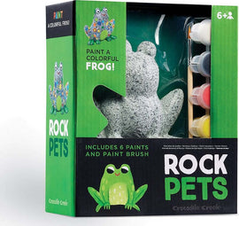 Rock Pets DIY kit by Crocodile Creek featuring a frog-shaped stone for painting. Includes six vibrant acrylic paints and a paintbrush, encouraging creativity for ages 6 and up.