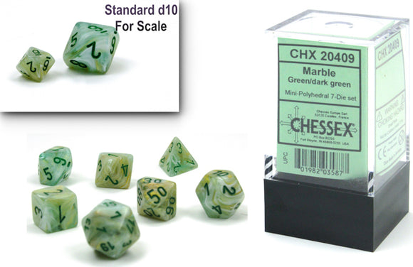 A clear display box containing a mini polyhedral 7-die set in marble green and dark green colors. The dice are numbered with black ink and include a standard d10 die for scale. Perfect for tabletop role-playing games.