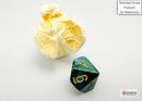 Chessex Scarab Mini in jade and gold polyhedral design, featured beside a piece of popcorn for scale. The die showcases intricate details and vibrant colors, perfect for tabletop gaming.