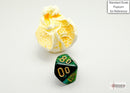 The Scarab Mini - Jade/gold polyhedral die is displayed on a light background, next to a piece of popcorn for scale. This vibrant D20 die features a deep green jade finish with gleaming gold numbers. Perfect for tabletop gaming and enhancing your collection.