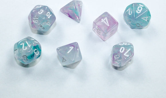 A vibrant set of Mini Nebula RPG dice in wisteria and white, featuring a mix of shapes including d20, d12, d10, d8, d6, and d4. The translucent dice showcase beautiful swirls of lilac and teal, making them perfect for tabletop gaming.