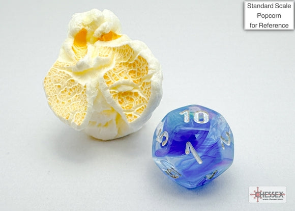 A close-up of a vibrant blue and white polyhedral die with silver numbers alongside a piece of popcorn for scale. The die showcases a unique swirl pattern, making it an eye-catching accessory for tabletop games.